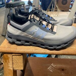 On Running Gray and Black Athletic Shoes with Reinforced Toe Caps